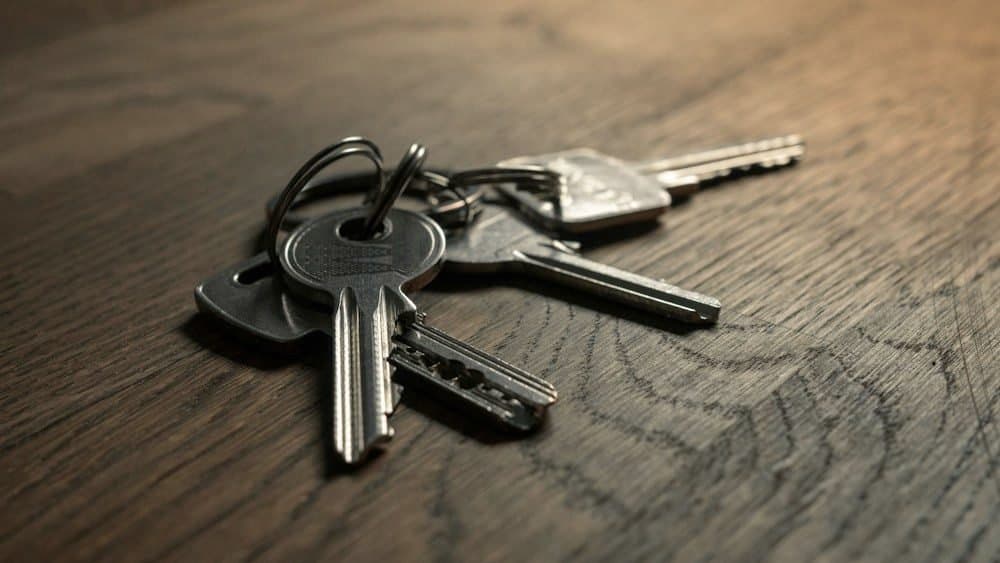 A bunch of keys on a wooden table